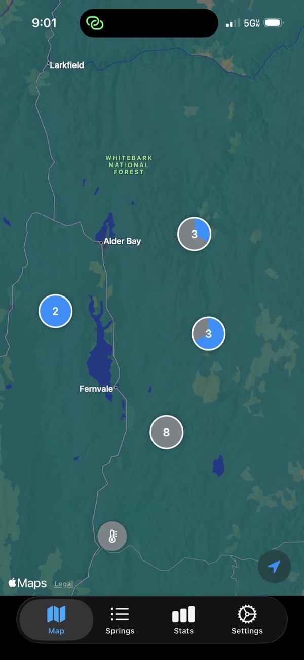 The HotSpringer map of a forested mountain region, showing saved springs grouped into clusters, with visited springs highlighted.